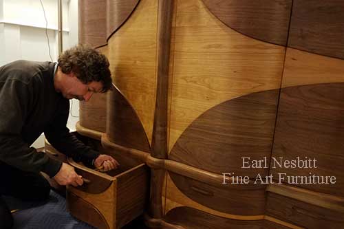 Earl attaching drawer pull to custom made art deco cabinet